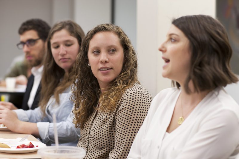 Students speaking in a panel discussion.