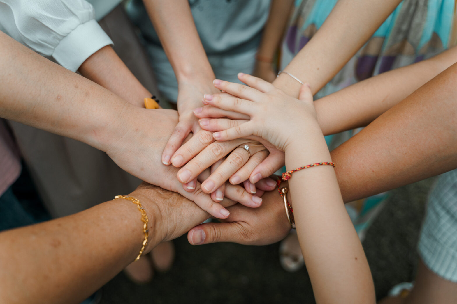 image of hands on top of each on other